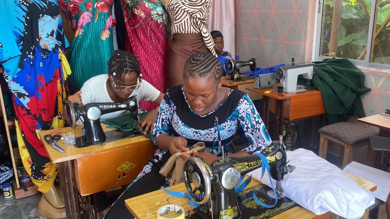 A trainee at a sewing machine in GAMAID vocational training