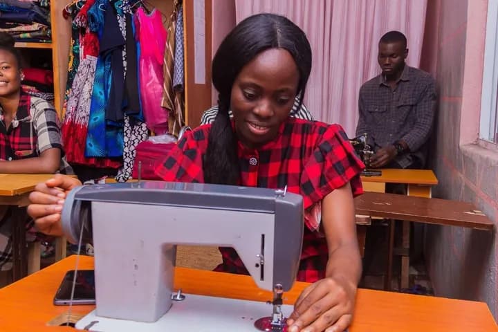 A trainee at a sewing machine in GAMAID vocational training