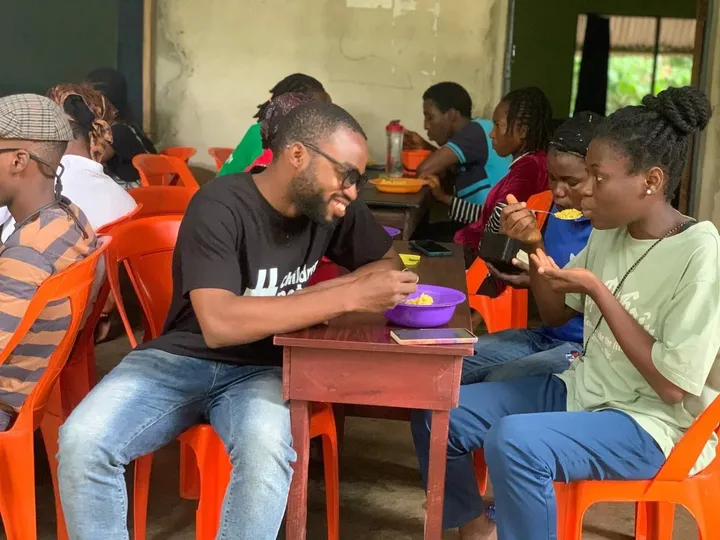 Guests sharing a meal at the GAMAID Kitchen
