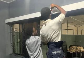 Trainees painting during GAMAID vocational training